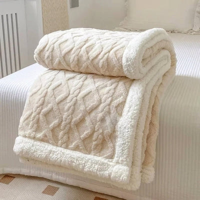 Eine doppelseitige Fleecedecke mit Lammwolle, die gemütlich auf einem Bett liegt.