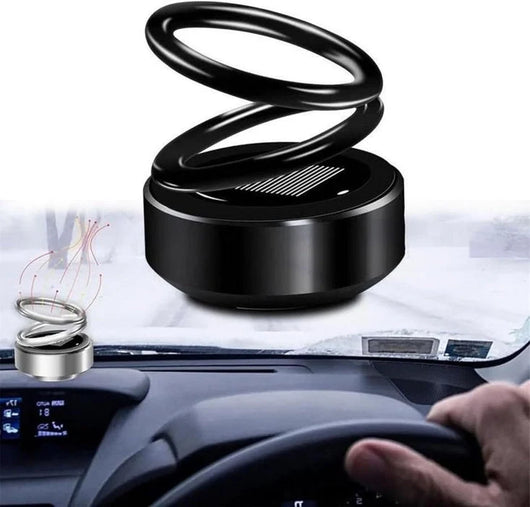 Ein kleiner kinetischer Molekularheizer in Ringform auf einem Armaturenbrett in einem Auto.