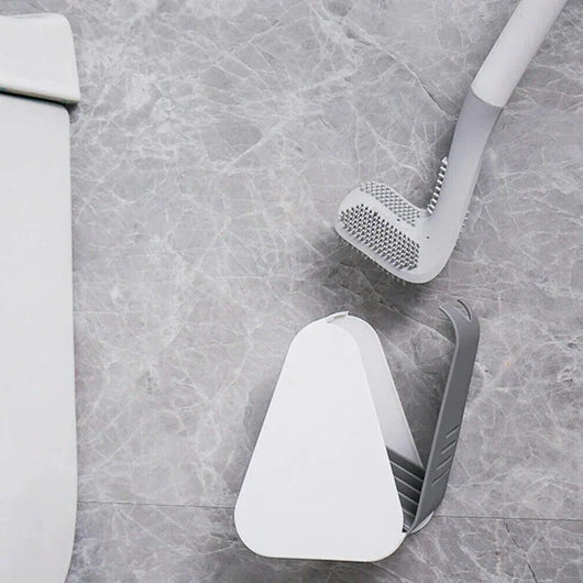 Toilettenbürste mit Selbstreinigungsfunktion und kompaktem Ständer auf einem grauen Fliesenboden.