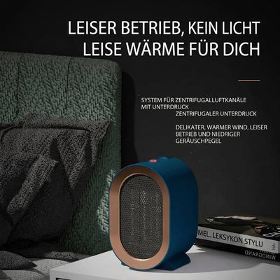 Ein kompakter, blauer Keramik-Heizlüfter steht auf einem Nachttisch neben einem Buch in einem gemütlichen Schlafzimmer.